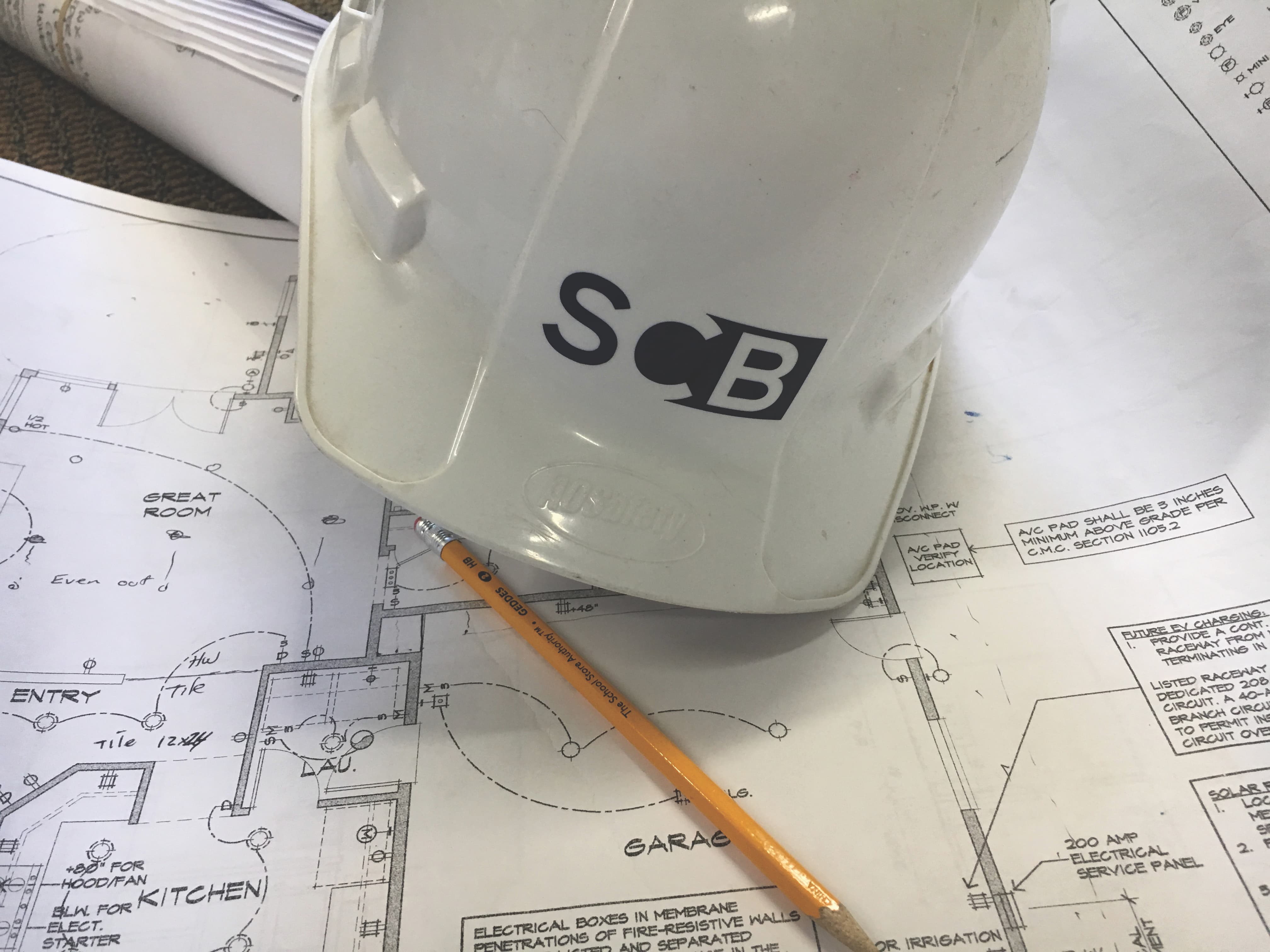 SCB Builders hardhat and blueprints - detailed planning for custom homes