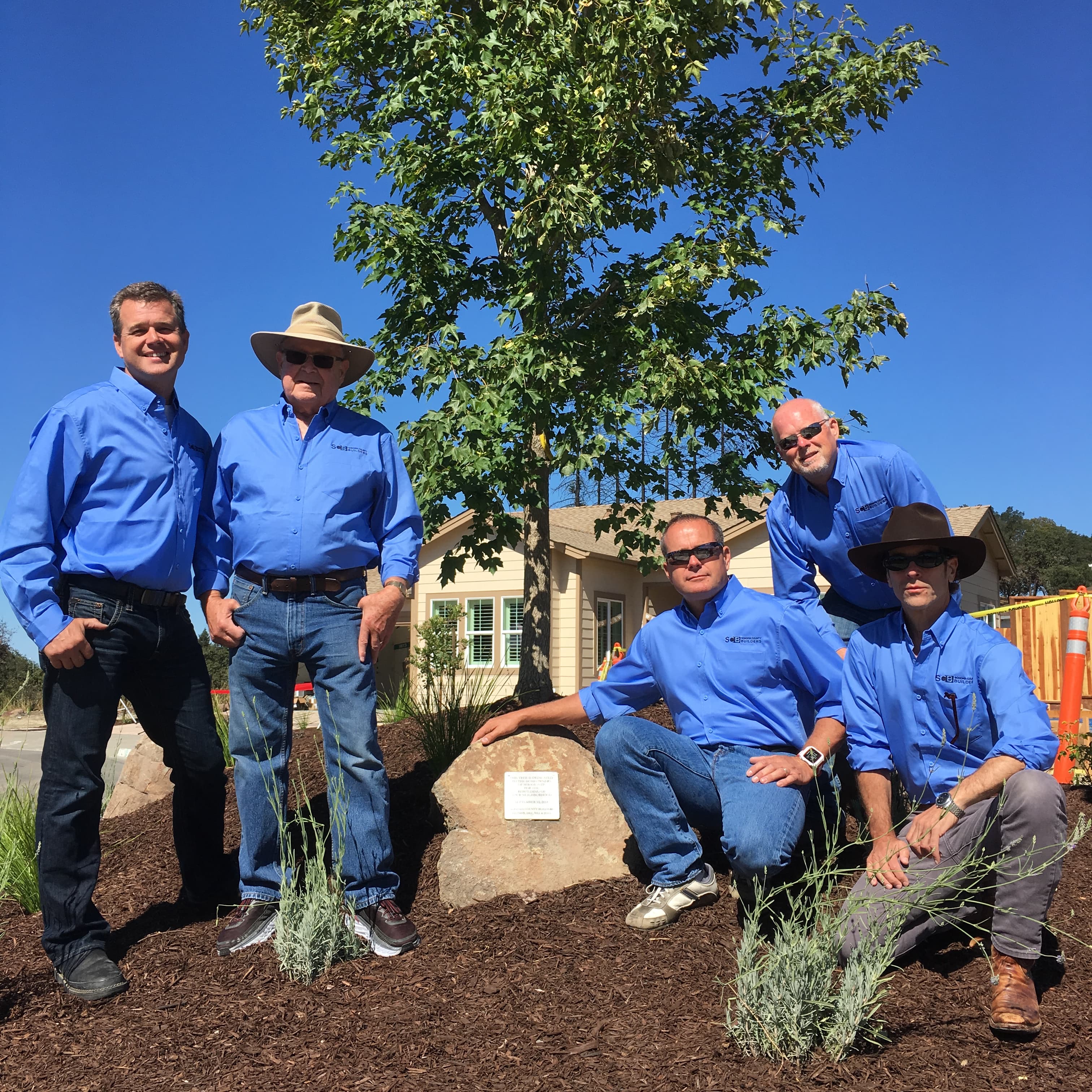 SCB Builders executive team planting memorial tree at completed home site